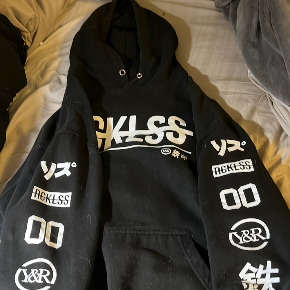 Young and reckless black hoodie with connecting front pocket